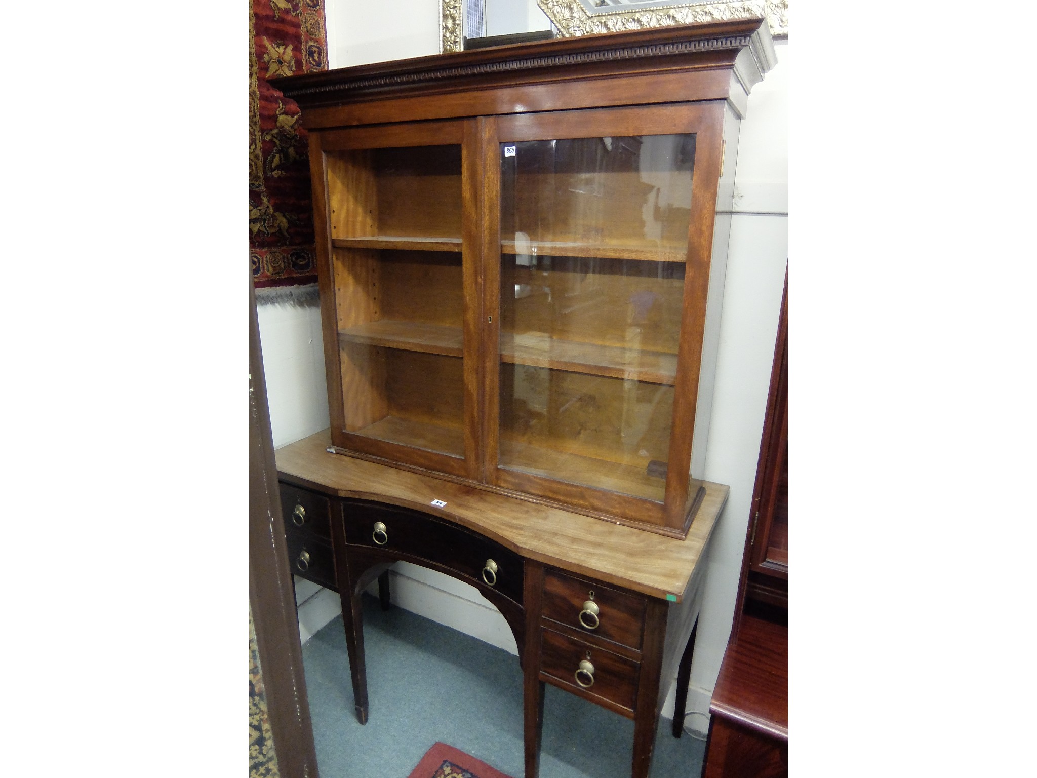 Appraisal: Mahogany glazed bookcase top with a mahogany desk