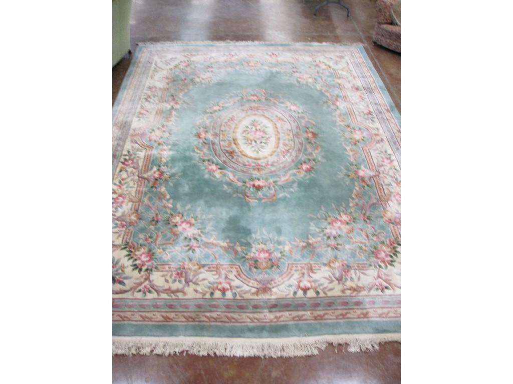 Appraisal: A Chinese Carpet with central oval panel with floral design