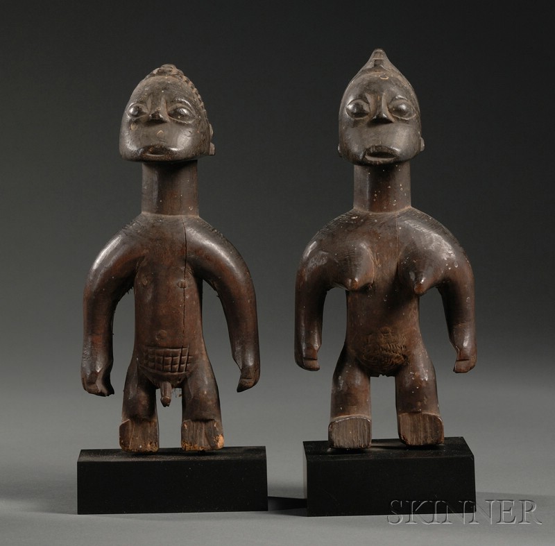 Appraisal: Pair of African Carved Wood Figures Fon the standing male