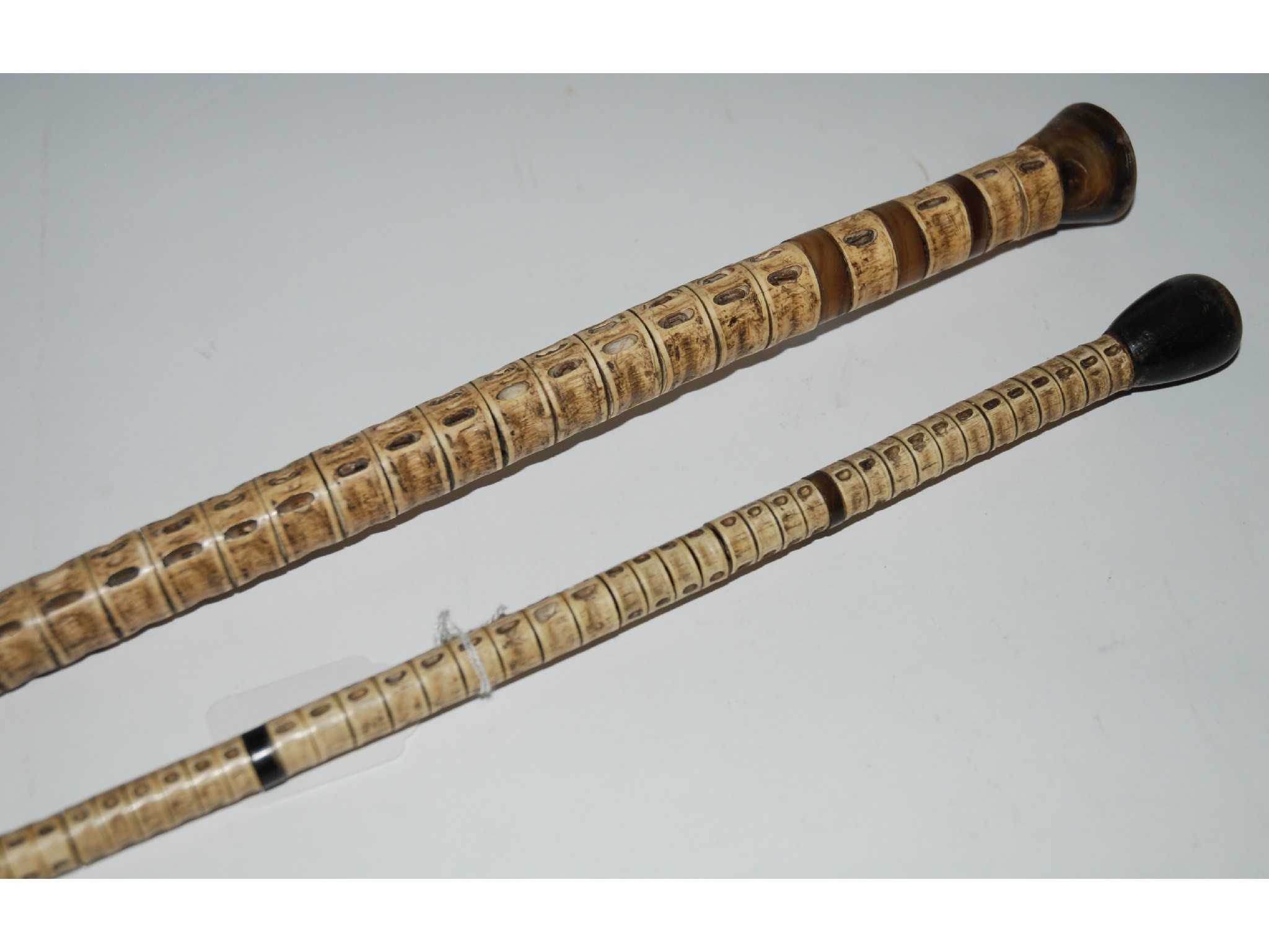 Appraisal: An early snake vertebrae walking cane and another damaged example