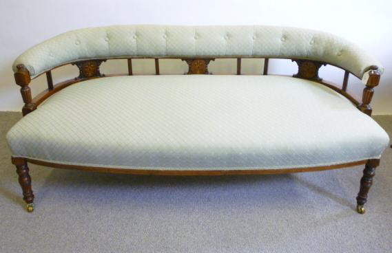 Appraisal: A LATE VICTORIAN WALNUT FRAMED SOFA of low curved form