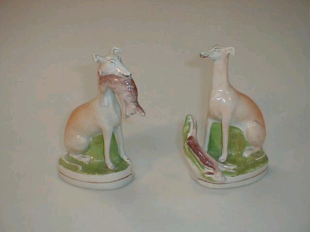 Appraisal: A pair of Victorian Staffordshire figures of hounds with rabbits