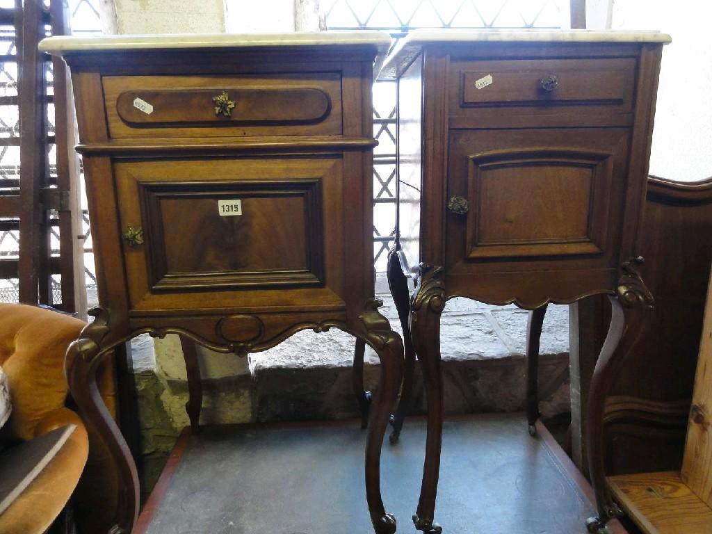 Appraisal: A continental mahogany bedside cupboard with white marble top over