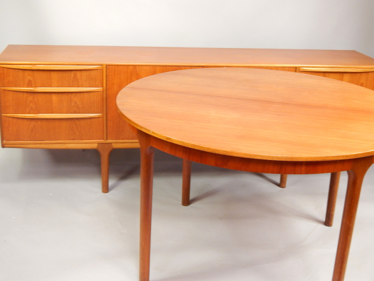 Appraisal: A s MacIntosh Co circular teak extending dining table on