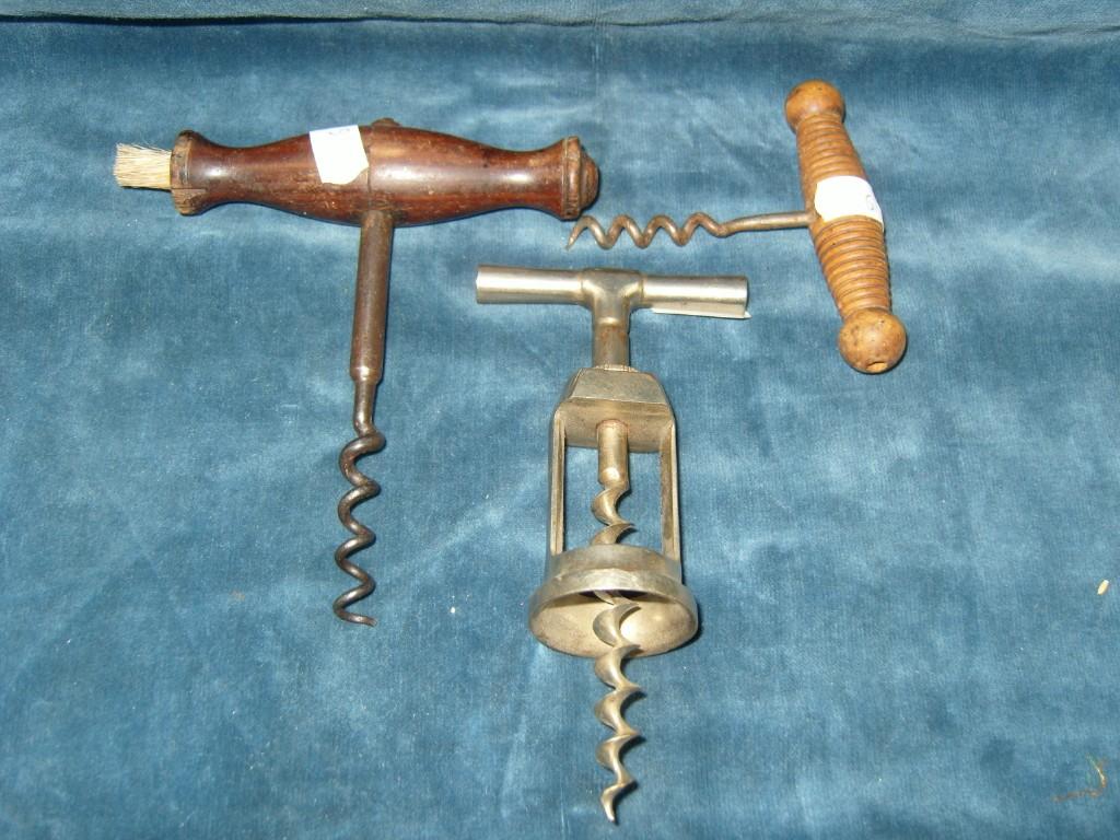 Appraisal: A Georgian corkscrew with mahogany handle together with further corkscrew