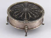 Appraisal: A silver circular velvet lined jewel box on four feet