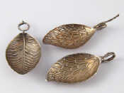 Appraisal: Three Georgian leaf shaped caddy spoons with tendril handles one