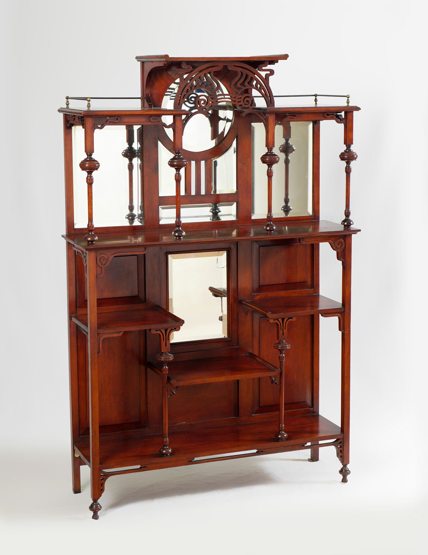 Appraisal: MAHOGANY CARVED EDWARDIAN ETAGERE Raided center top over pierced openwork