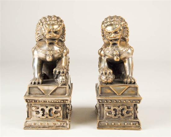 Appraisal: A Pair of Chinese Silvered Metal Foo Lions resting on