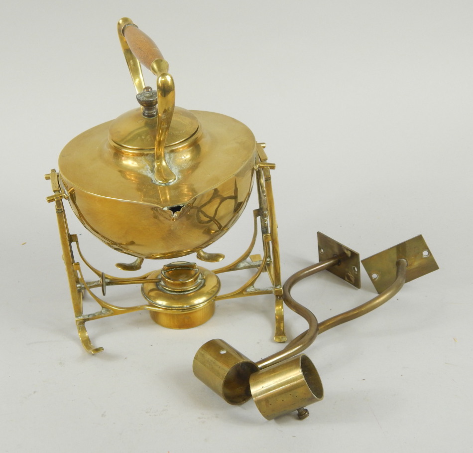 Appraisal: An Arts Crafts style brass kettle on stand with turned