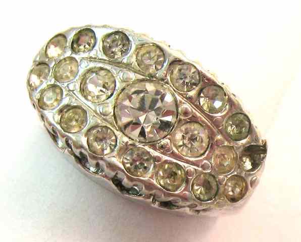 Appraisal: RHINESTONE AND PLATINUM RING set with round-cut rhinestones one missing