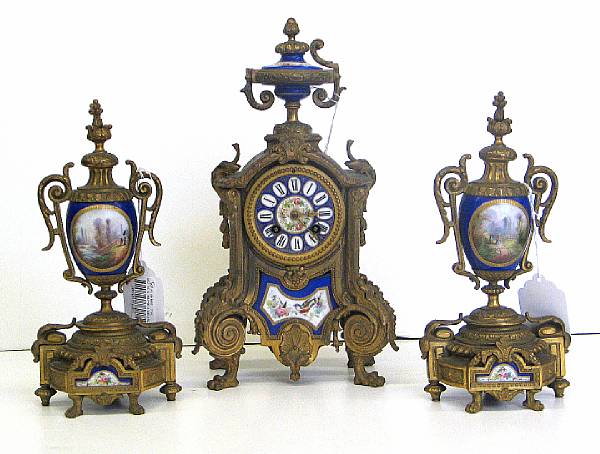 Appraisal: A French porcelain mounted gilt metal three piece clock garniture