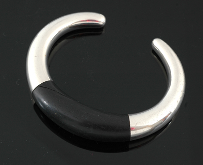 Appraisal: A silver and ebony bangle by Georg Jensen Designed by