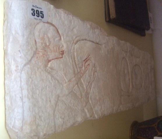 Appraisal: A stone plaque carved in relief with a single African