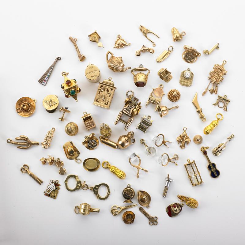 Appraisal: SIXTY-TWO NOVELTY YELLOW GOLD CHARMS Includes Domestic hat and utensil