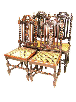 Appraisal: Four matching beech chairs with foliate carved pierced backs above