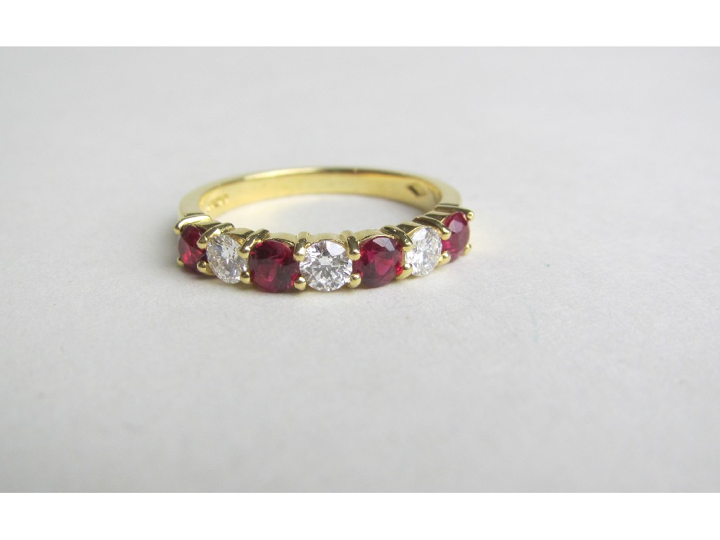 Appraisal: Eighteen carat gold ruby and diamond seven stone half hoop