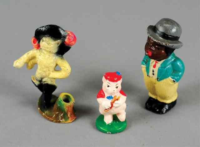 Appraisal: WHIMSICAL CHARACTER PAPERWEIGHTS Cast iron includes Puss and Boots with