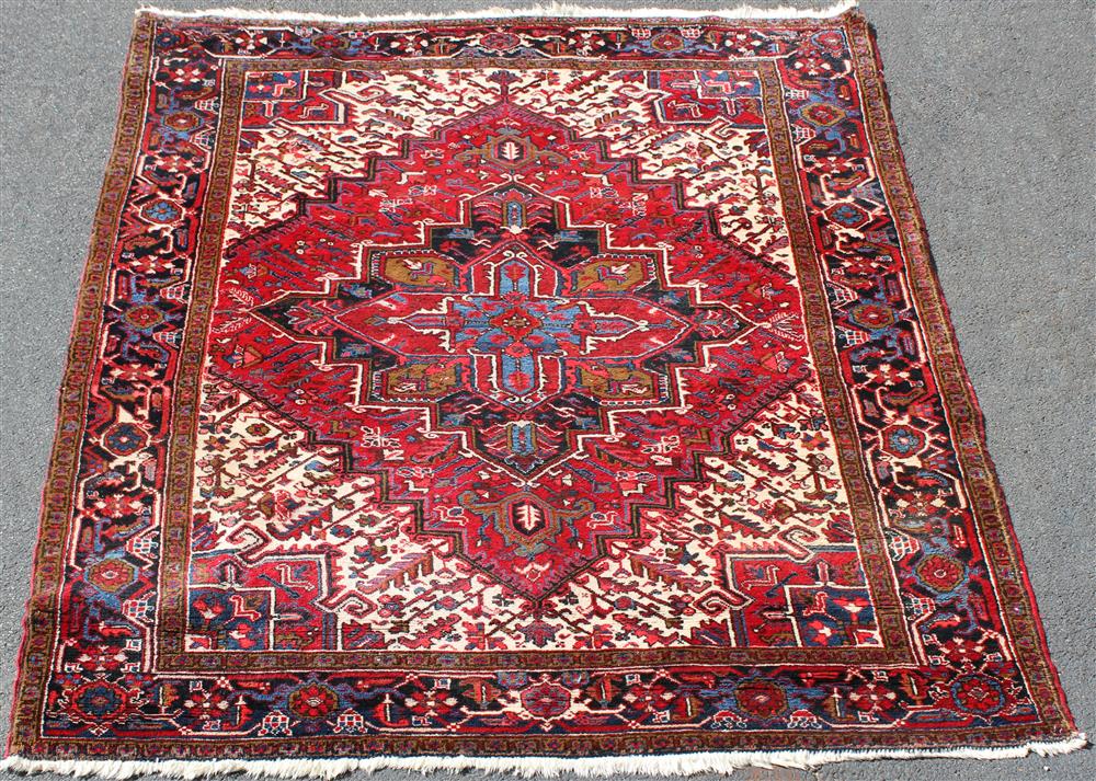 Appraisal: HERIZ WOOL RUG center medallion on a red field surrounded