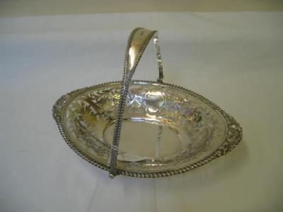 Appraisal: A FRUIT BASKET of oval form with swing loop handle