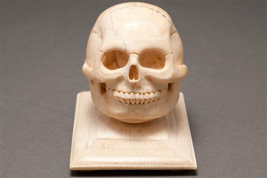 Appraisal: Continental or Chinese carved ivory skull-form cane top and an