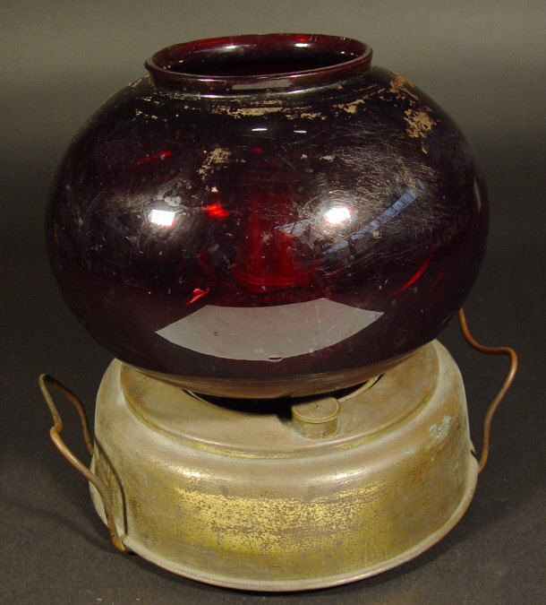 Appraisal: Victorian brass paraffin hall heater with ruby glass globular shaped