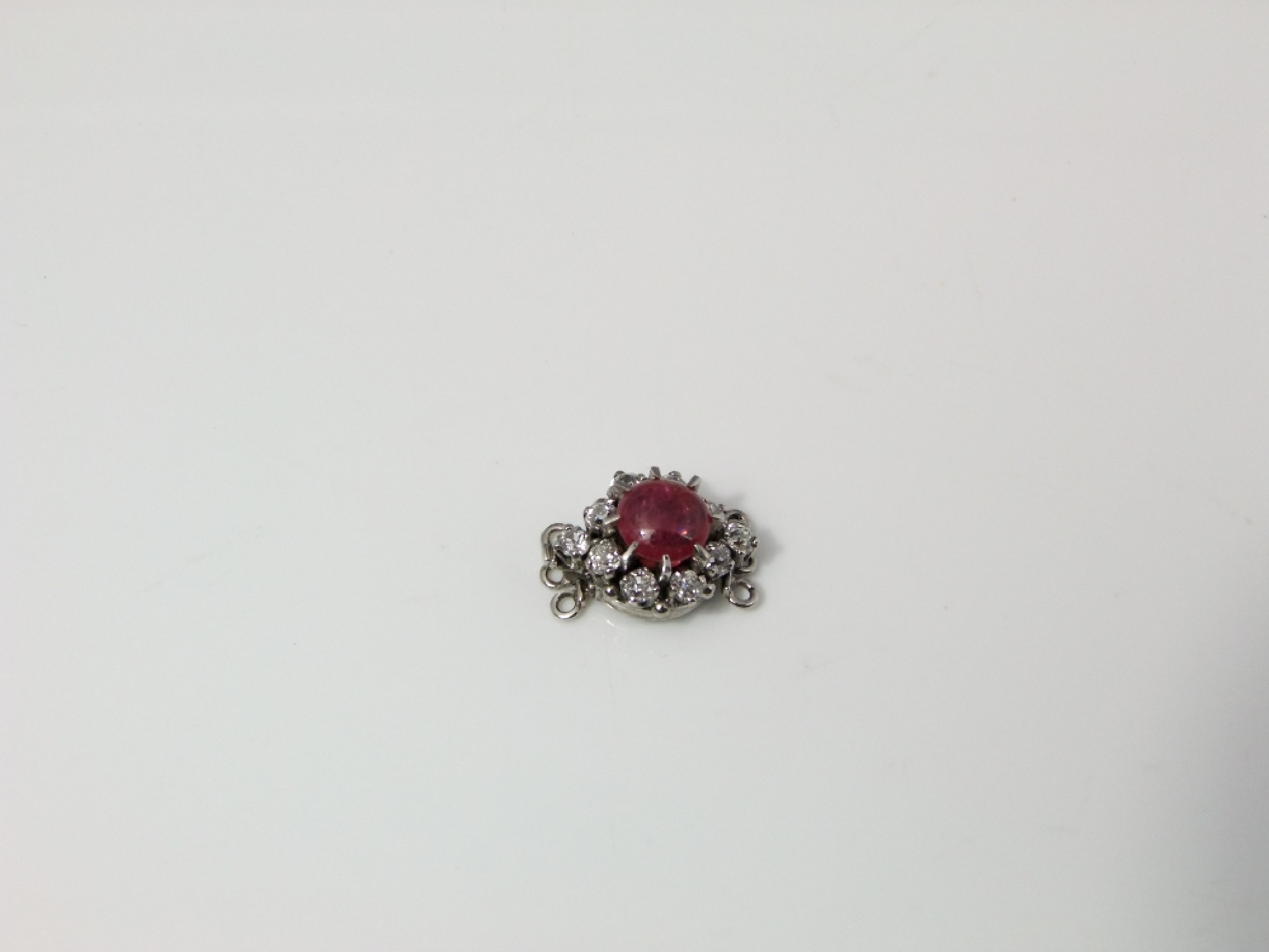 Appraisal: A white gold set clasp mounted with diamonds and rubies