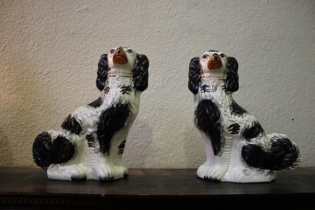 Appraisal: A PAIR OF VICTORIAN STAFFORDSHIRE POTTERY MODEL SPANIELS cm high