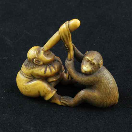 Appraisal: A comical Edo period ivory netsuke carved as a monkey