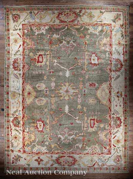 Appraisal: An Oushak Rug muted greens blues yellows and reds ft