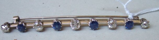 Appraisal: A diamond and sapphire set nine stone bar brooch claw