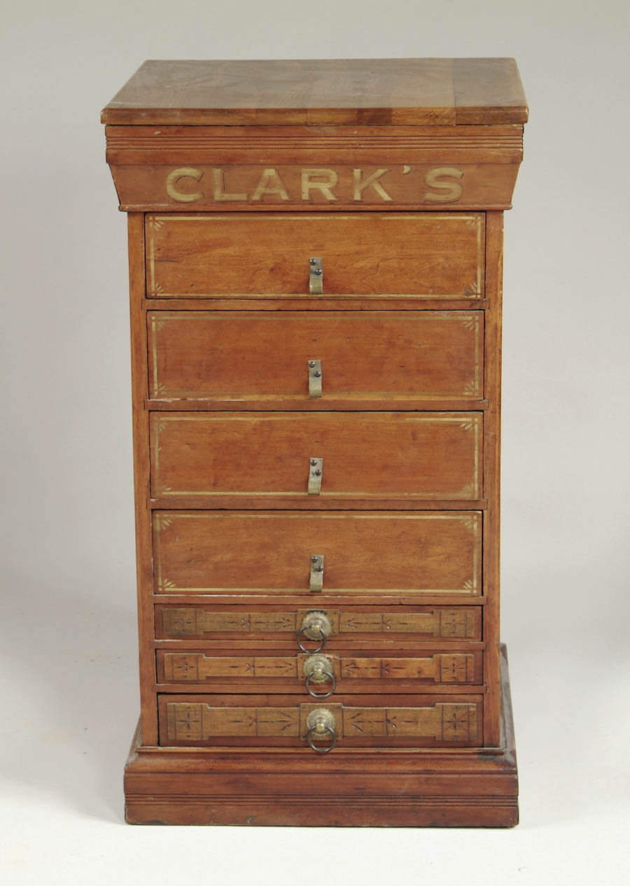 Appraisal: CLARKS SEVEN DRAWER RIBBON CABINET Maple cabinet with walnut top