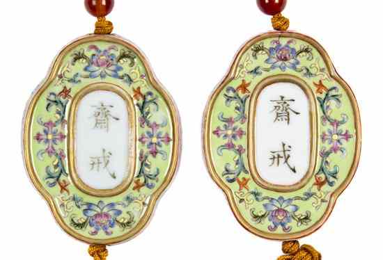 Appraisal: A Pair of Porcelain Enameled Buddhist Abstinence Pendants each of