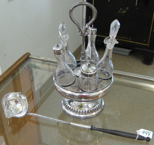 Appraisal: A SILVER PLATED CASTOR STAND AND A SHEFFIELD PUNCH LADLE