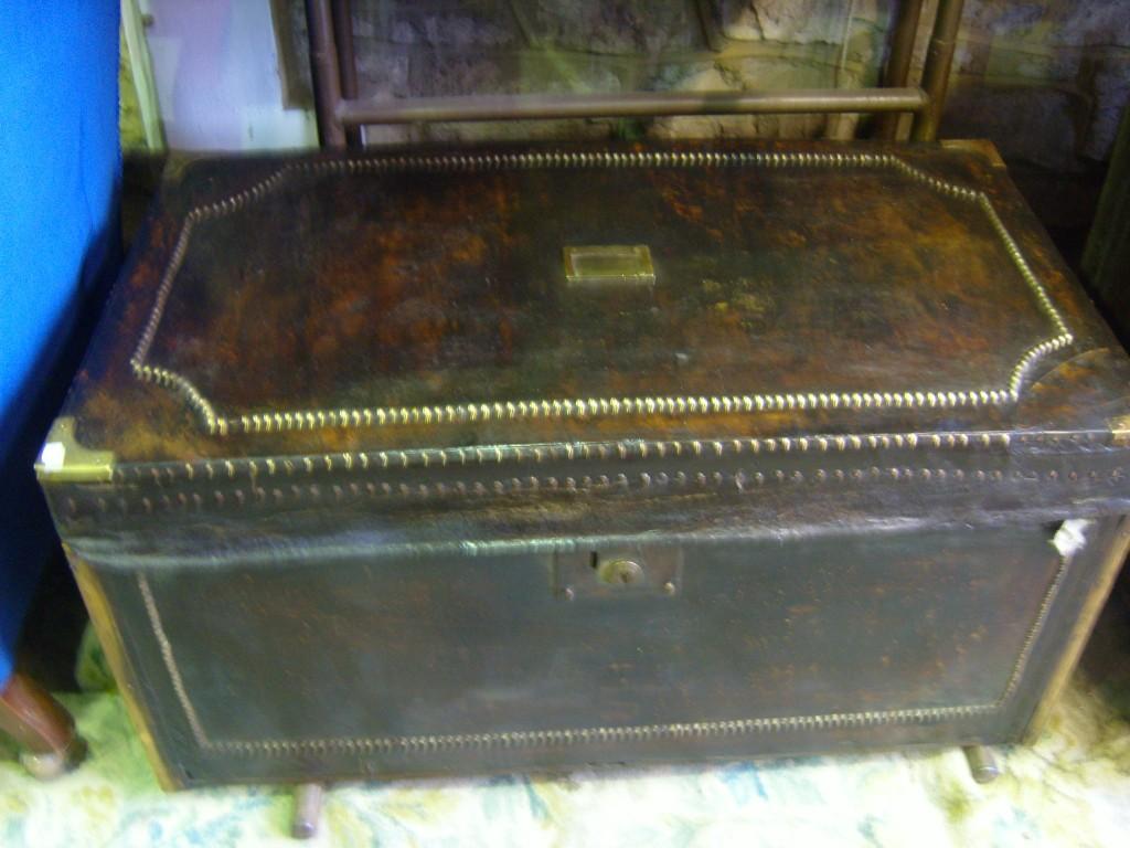 Appraisal: A th century hide bound travelling trunk with brass fittings