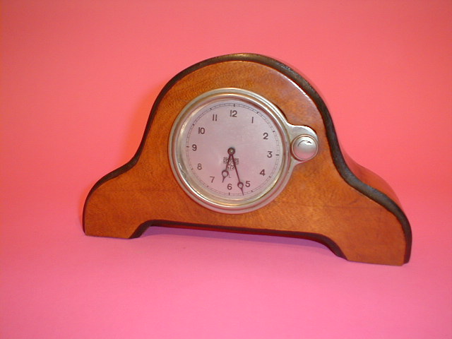 Appraisal: A Smiths dashboard clock mounted in a walnut case