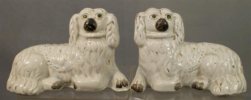 Appraisal: Pr Staffordshire recumbant white spaniels black gold trim craquelure good