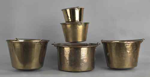 Appraisal: Five brass pots with iron swing handles largest - h