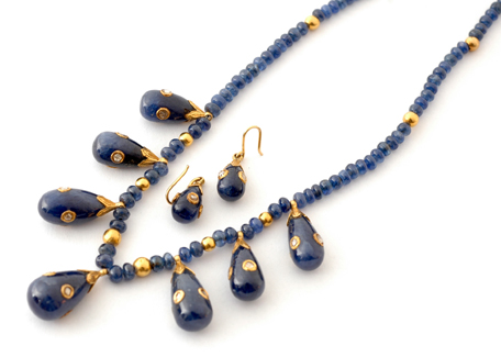 Appraisal: A sapphire and diamond necklace and earrings Comprising polished sapphire