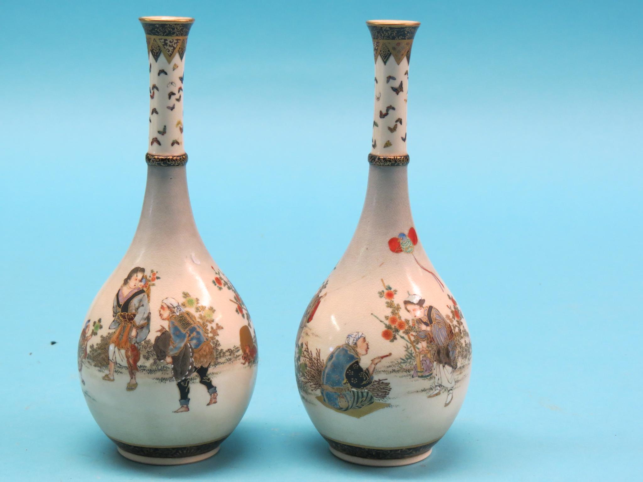 Appraisal: A pair of Satsuma bottle vases painted with playful figures