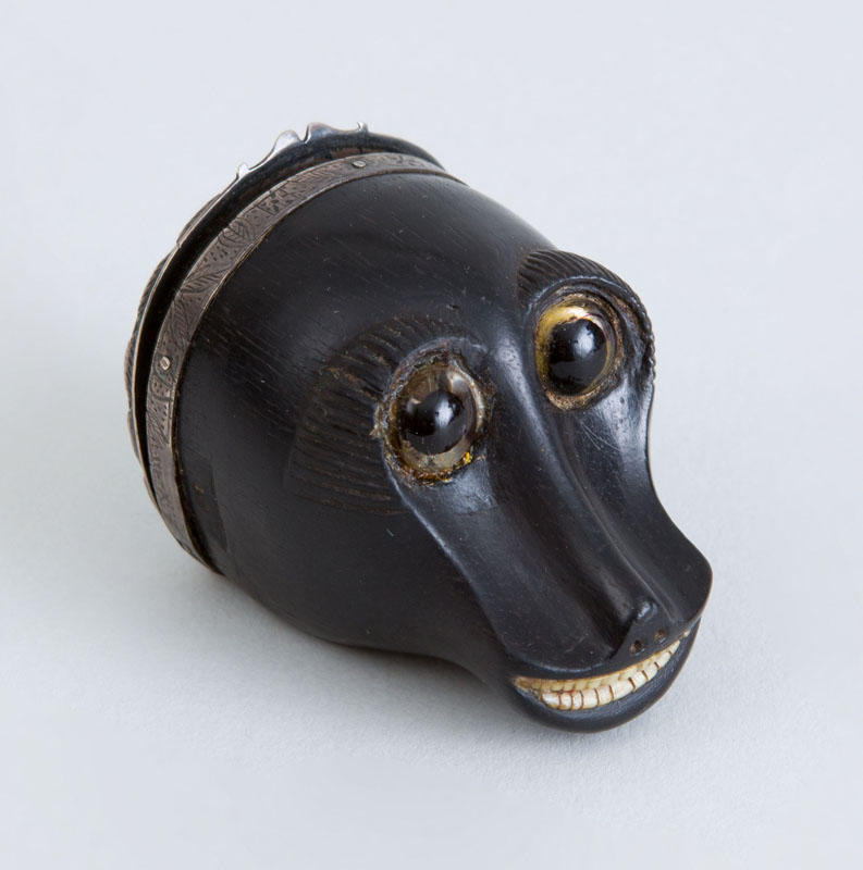 Appraisal: SILVER-MOUNTED CARVED EBONY MONKEY-HEAD SNUFF BOX The smiling head inset