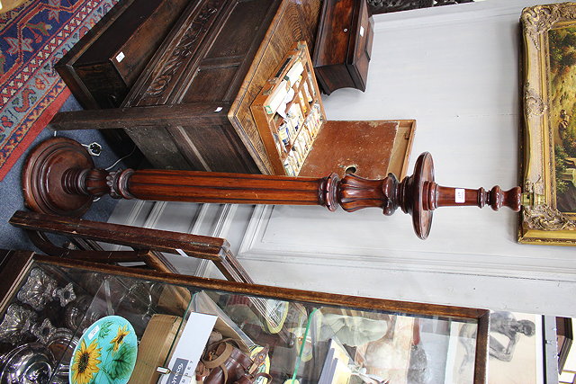 Appraisal: A MAHOGANY LAMP STANDARD with reeded column and turned spreading