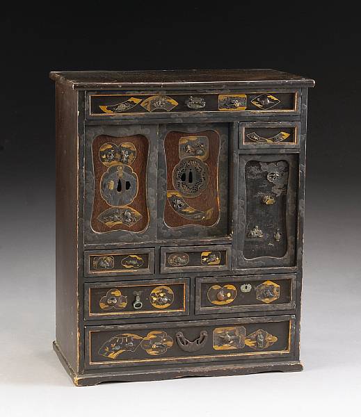 Appraisal: A small tansu decorated with tsuba and sword fittings Meiji