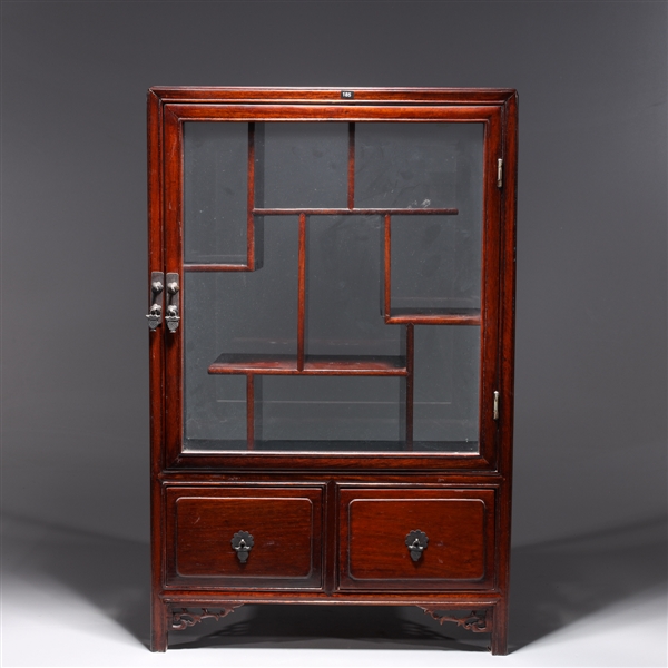 Appraisal: Old Chinese hardwood curio cabinet with glass door and numerous