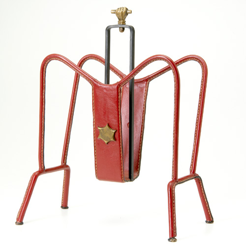 Appraisal: JACQUES ADNET Leather and cast-iron magazine rack with applied brass