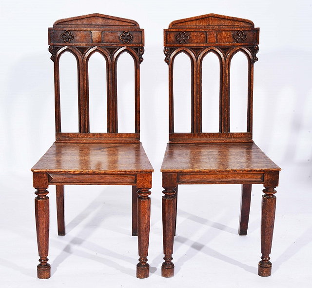 Appraisal: A PAIR OF VICTORIAN GOTHIC REVIVAL CARVED HALL CHAIRS on