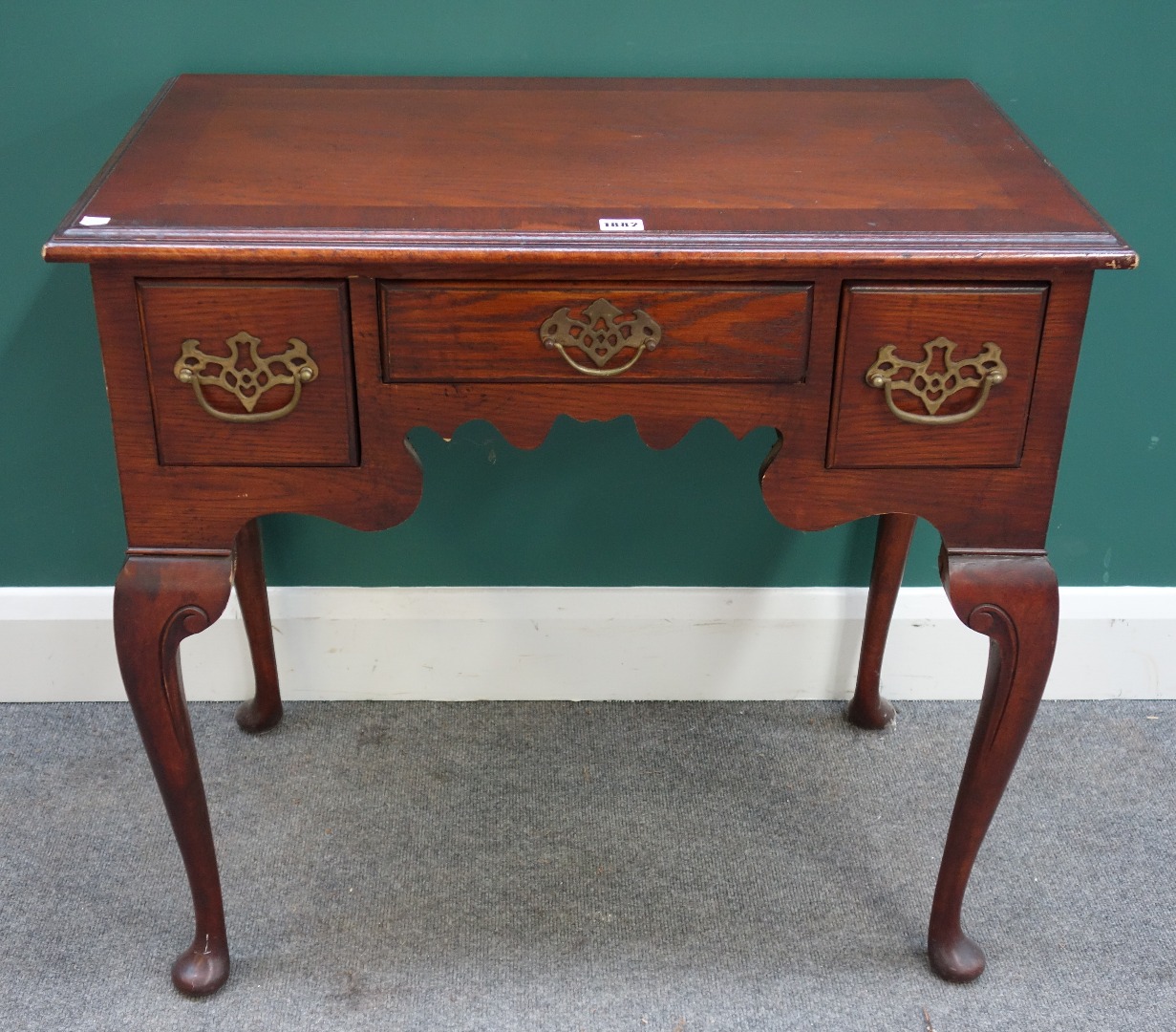 Appraisal: A George III style mahogany and oak three drawer lowboy