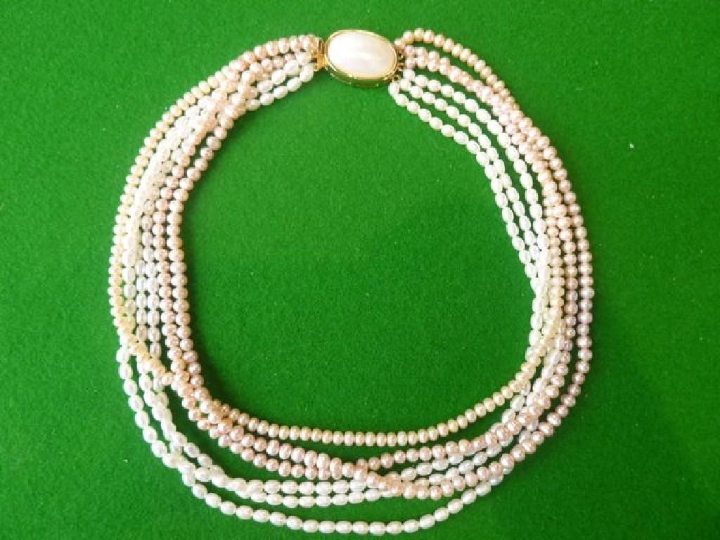 Appraisal: A three stand graduated pearl necklace with mother-of-pearl clasp