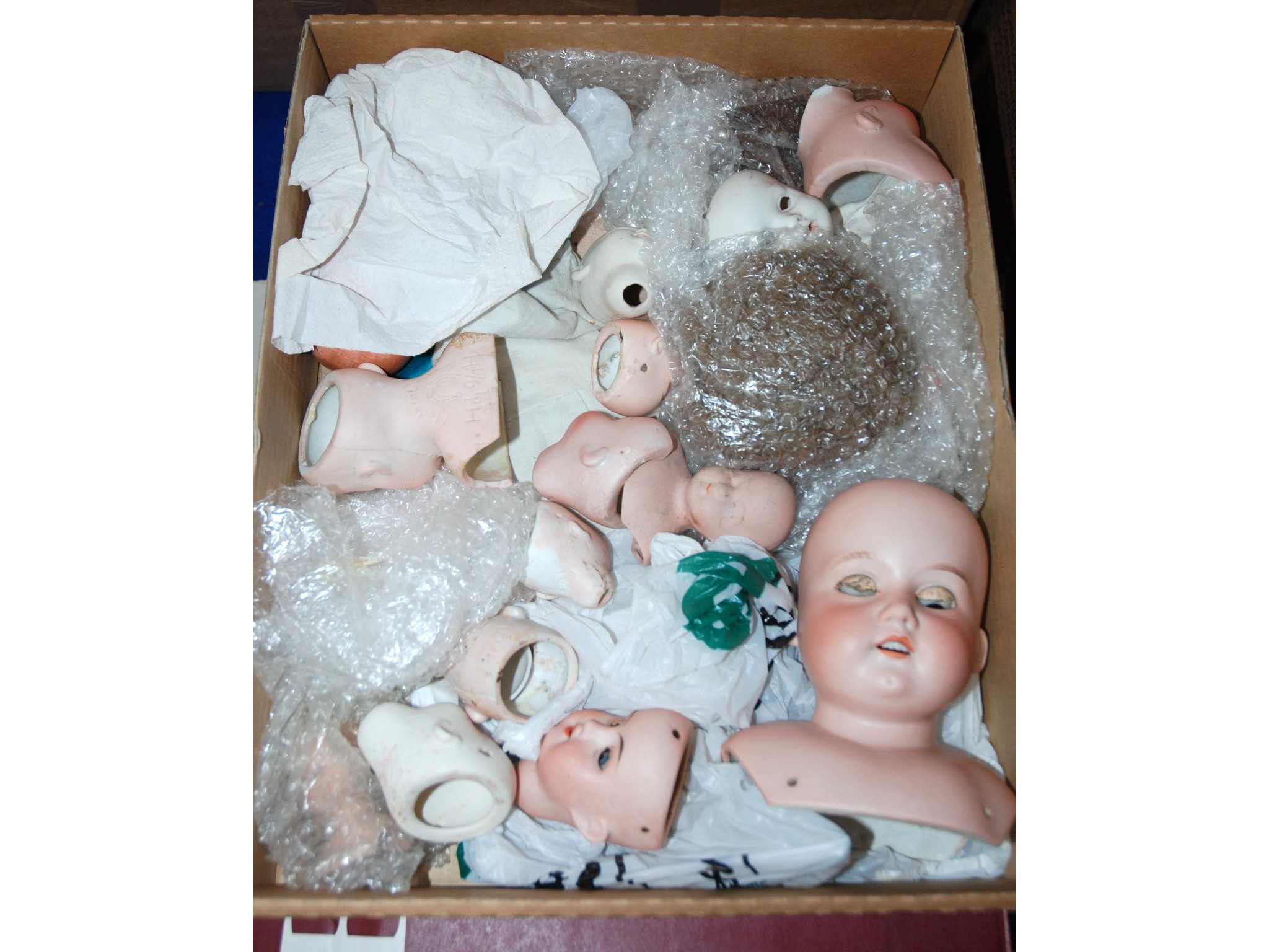 Appraisal: A collection of bisque dolls head and some body parts