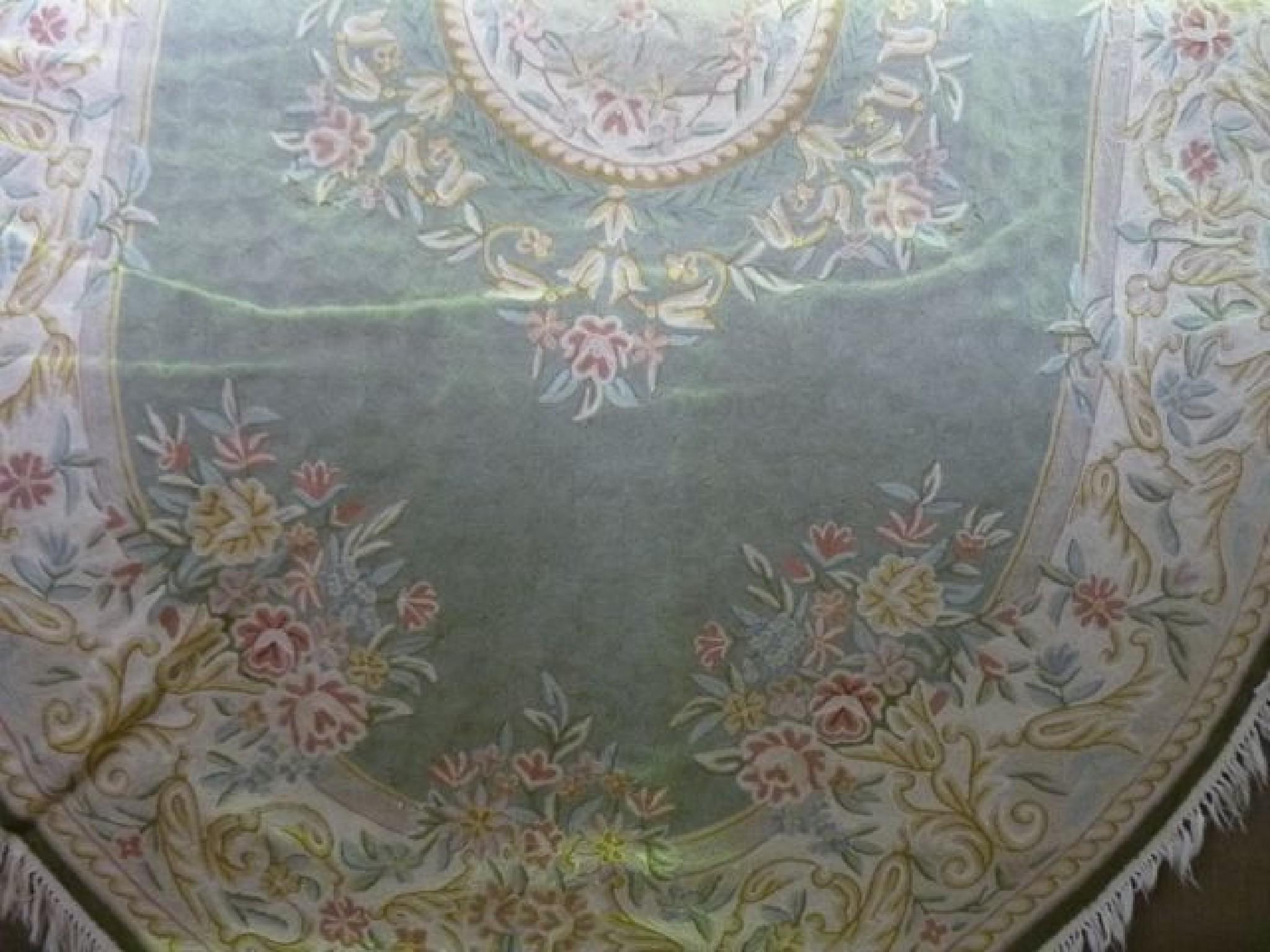 Appraisal: A chain stitch rug of oval form with floral panels